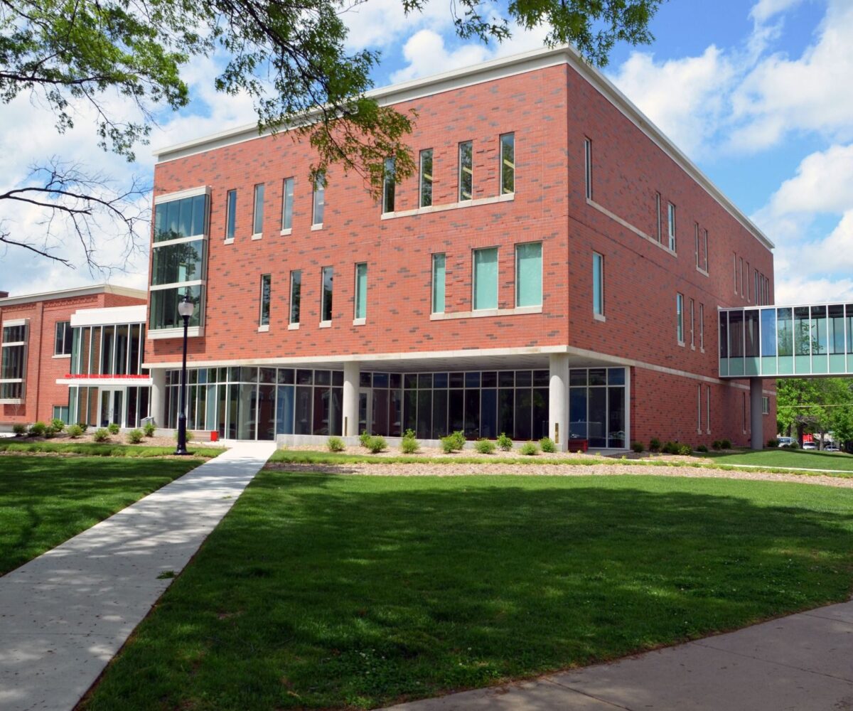 Modern brick building with glass walkway, the Judy and Glenn Rogers Fine Arts building at Cottey College.