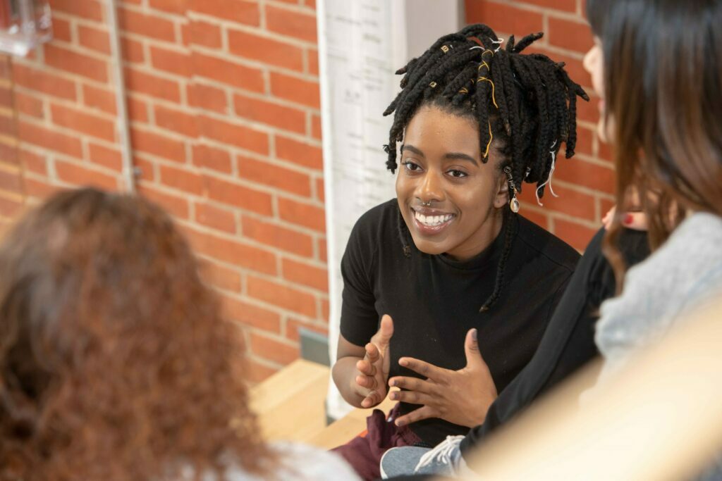 Cottey student studying with her peers, excitedly explaining a concept.