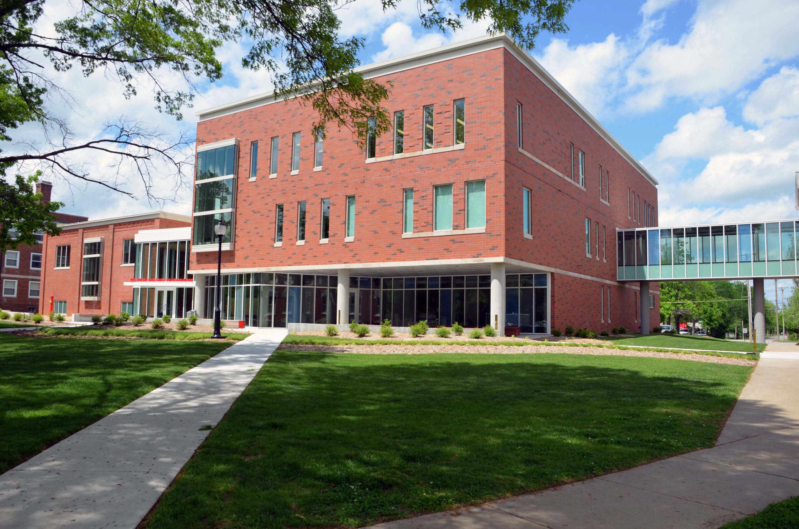 Modern red brick building with glass sky walk