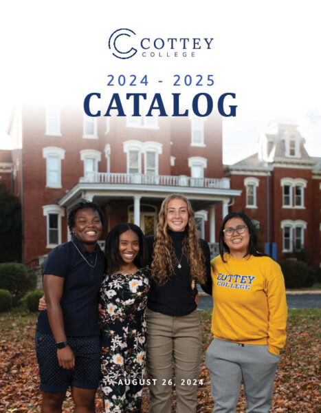 College students standing in front of a historical brick building.