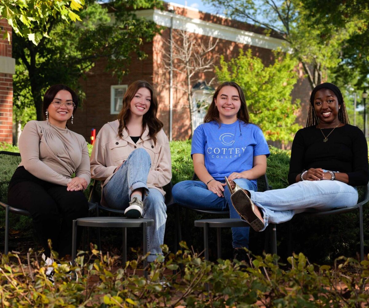 Your college students smiling and lounging outside