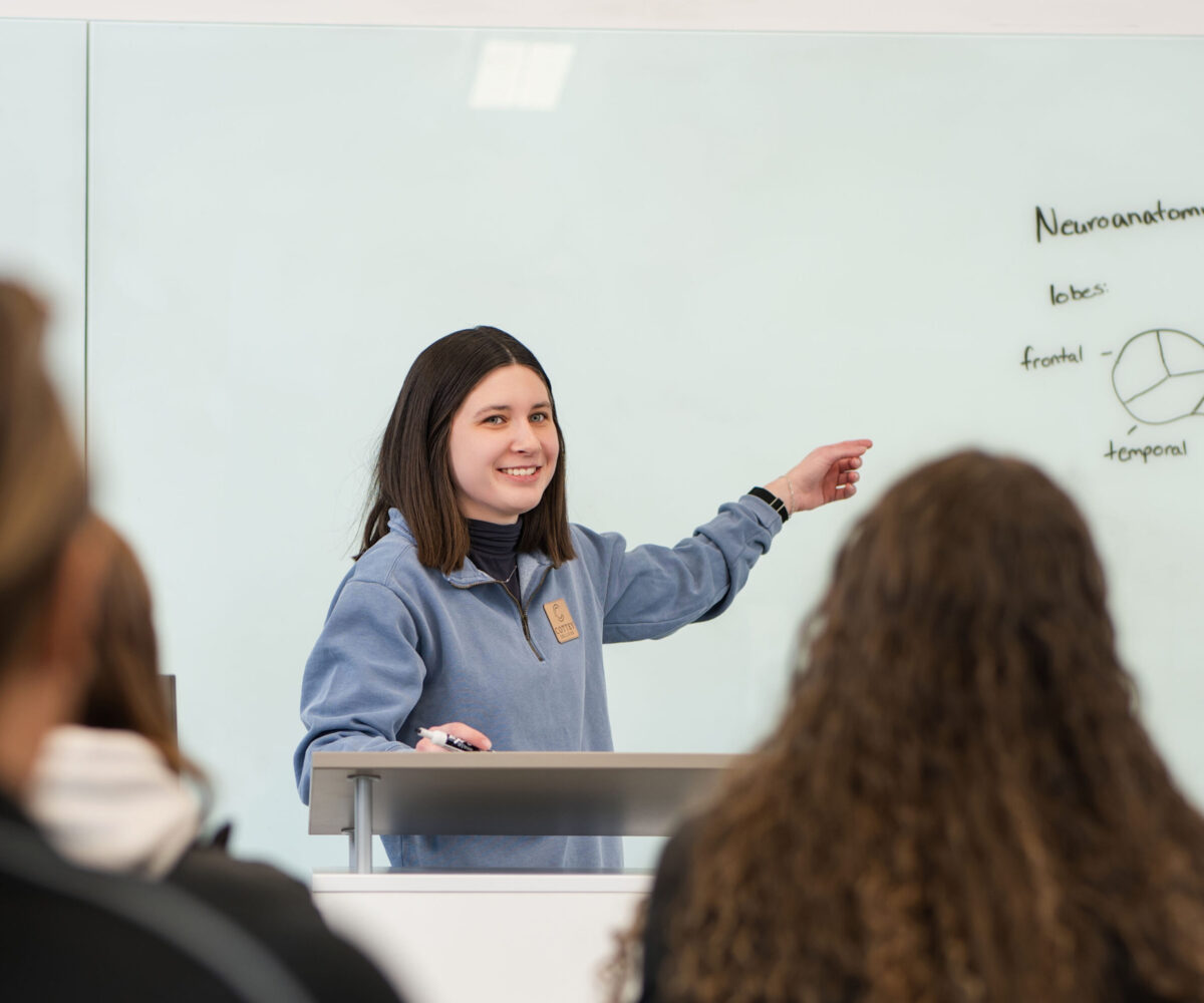 A Cottey College student giving a presentation in front of the class.