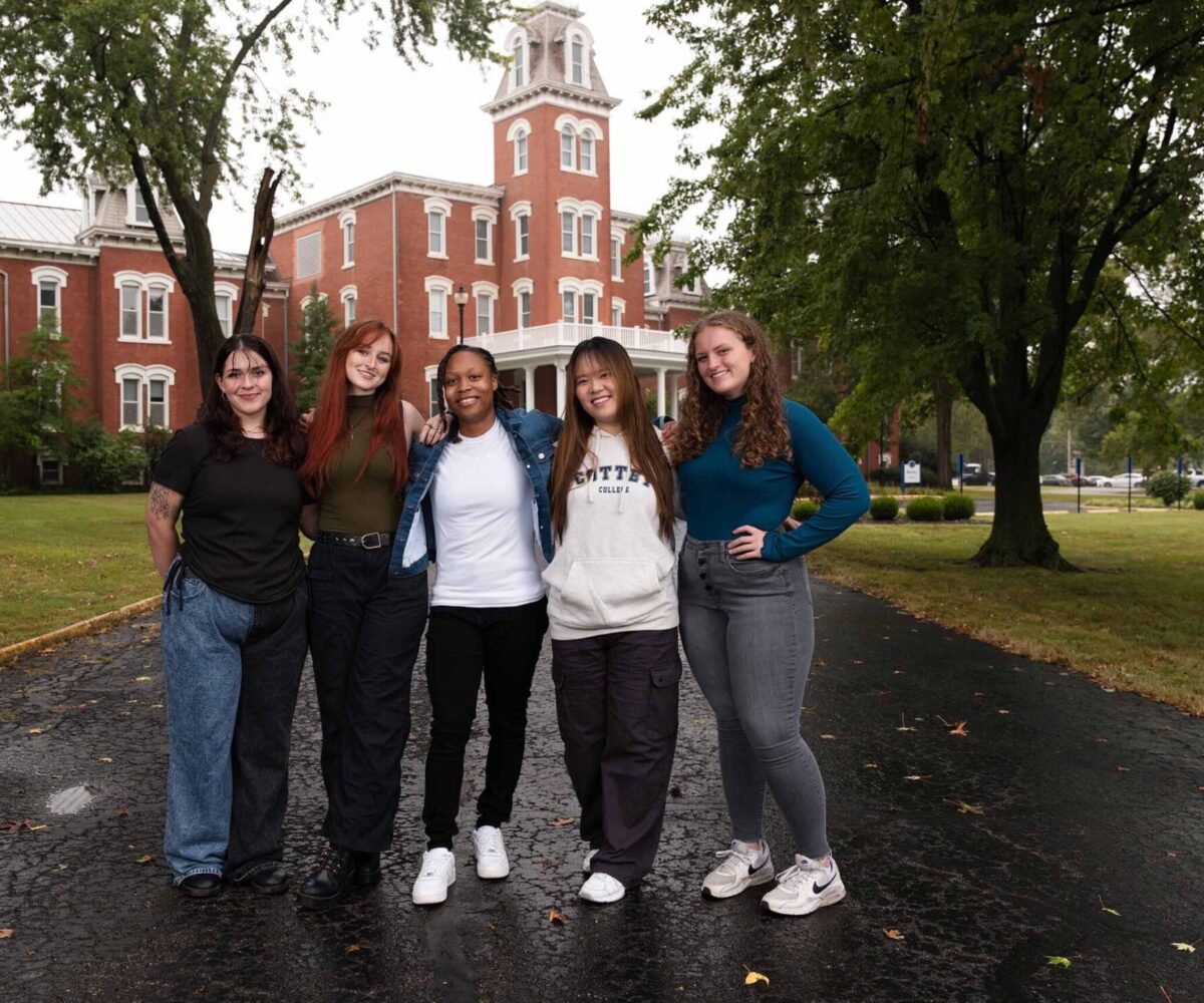Five Cottey students standing in front of historic Main Hall.