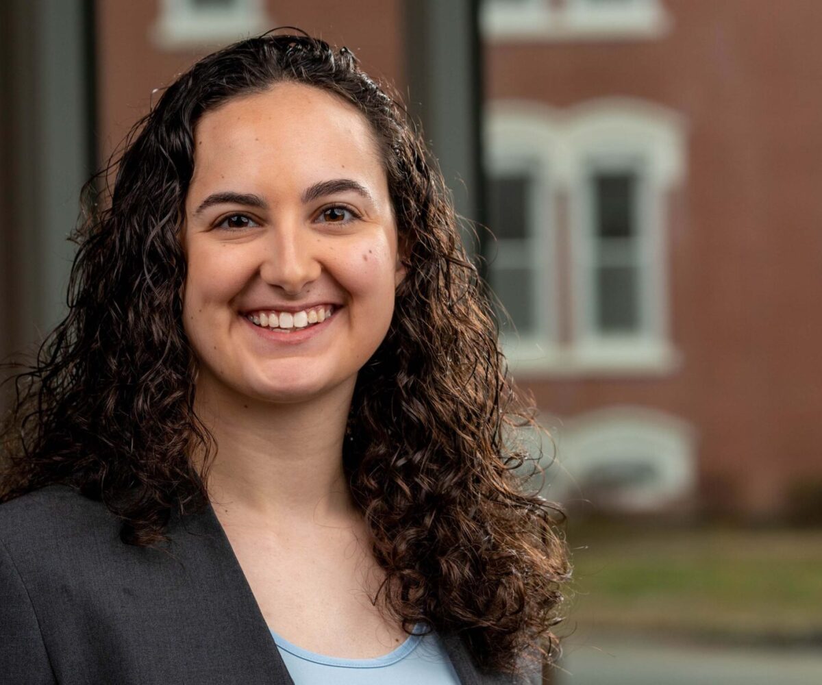 Cottey student wearing a gray business suit and smiling into the camera.