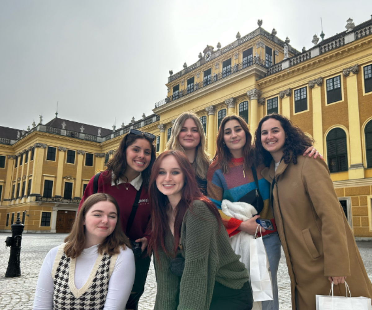 Cottey students posing in front of a large European building.