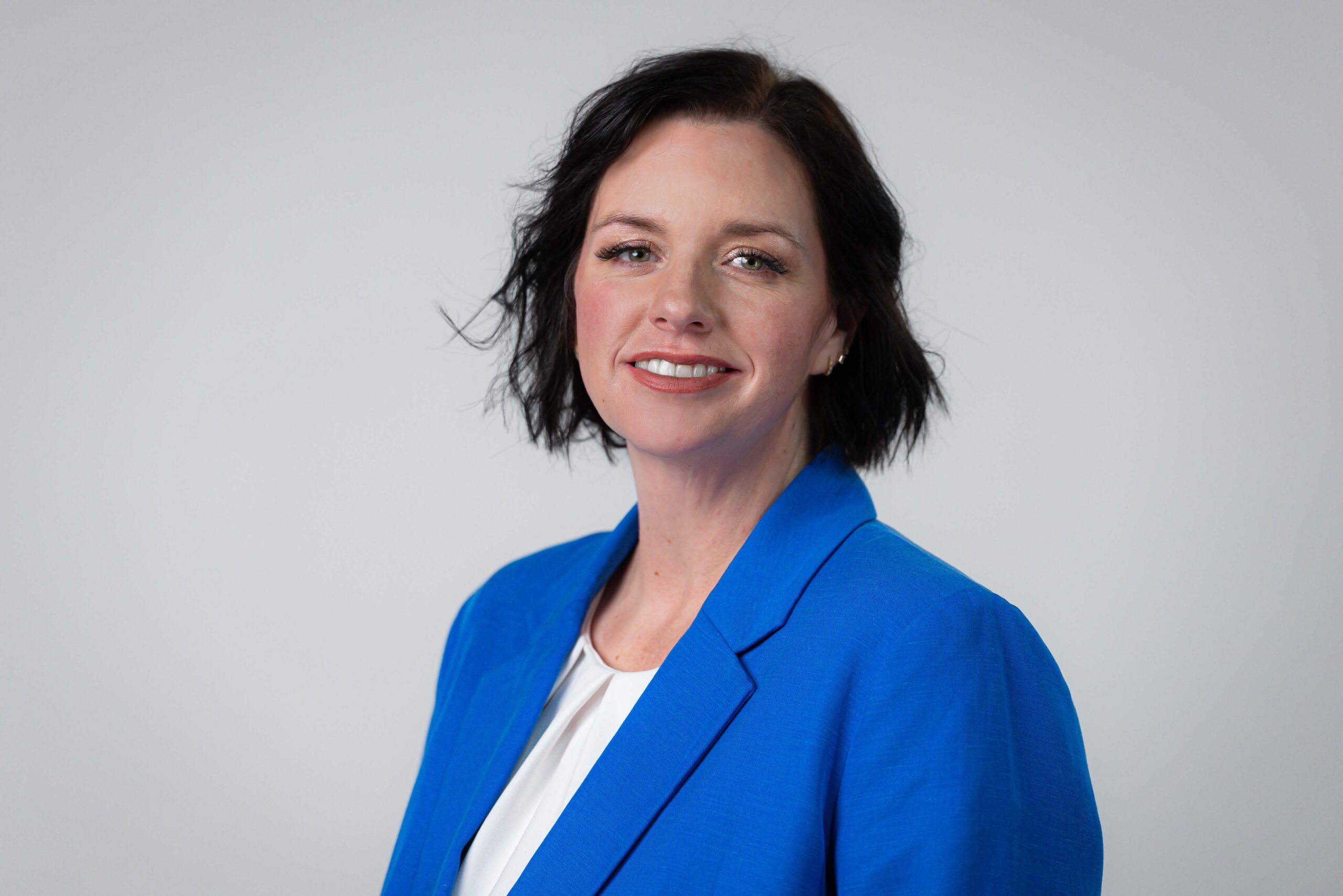 Woman with blue blazer and white shirt.